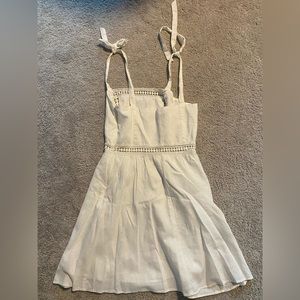 White cotton mini dress with shoulder and floral detailing